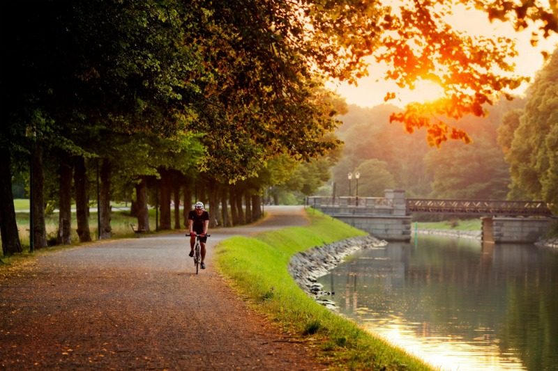 Bicycle rider cycles through park in stockholm